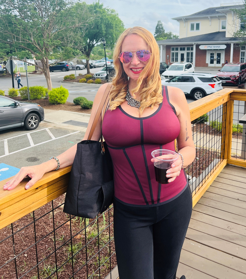 Denise having a glass of wine on a patio