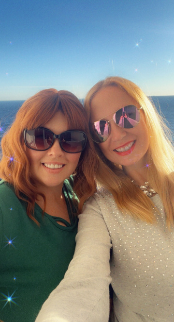 Cheryl and Denise taking a selfie in front of the ocean