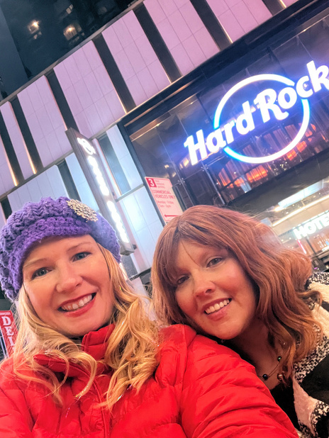 Cheryl and Denise pose for a selfie in front of the hard rock cafe